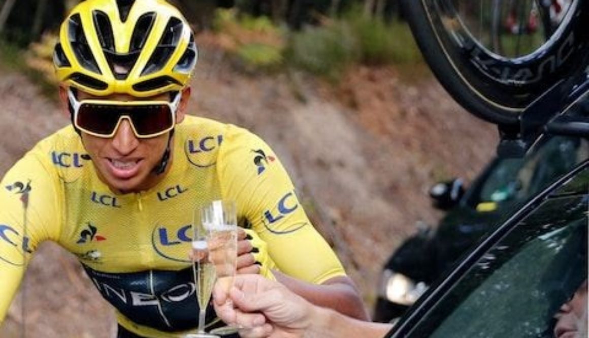 Bernal toasts with champagne at the car of his team director Credit: AP